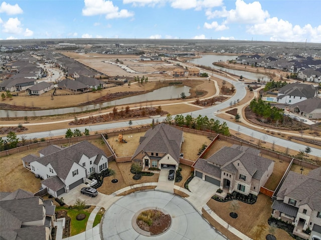 drone / aerial view featuring a water view and a residential view