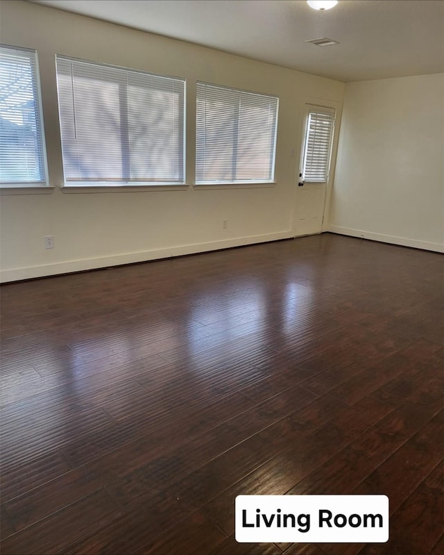 empty room featuring dark wood-type flooring