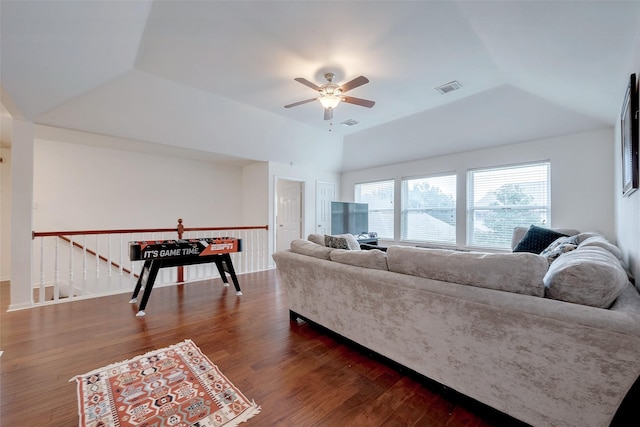 living room featuring dark hardwood / wood-style flooring, lofted ceiling, and ceiling fan