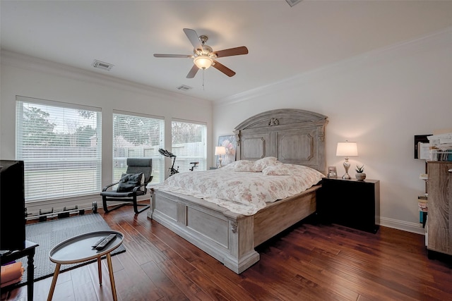 bedroom featuring dark wood-type flooring, ceiling fan, and ornamental molding