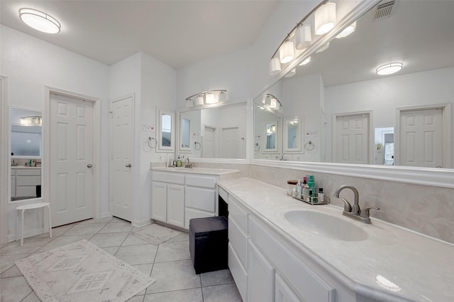 bathroom featuring tile patterned flooring and vanity