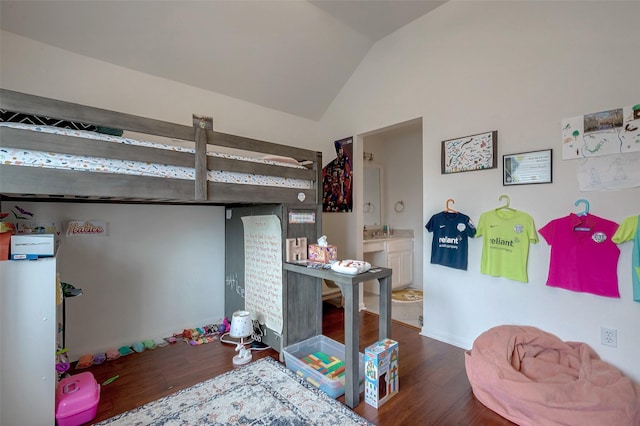 bedroom with vaulted ceiling and dark wood-type flooring