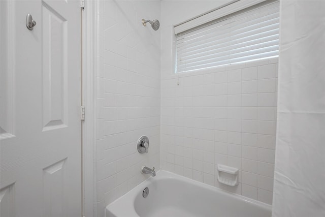 bathroom featuring shower / bath combo with shower curtain