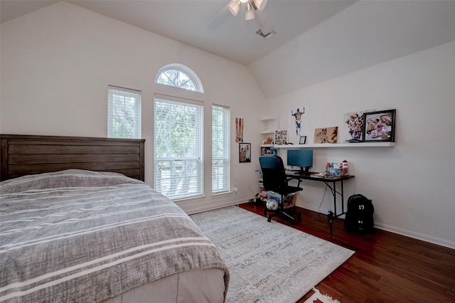 bedroom featuring dark hardwood / wood-style flooring, vaulted ceiling, and ceiling fan