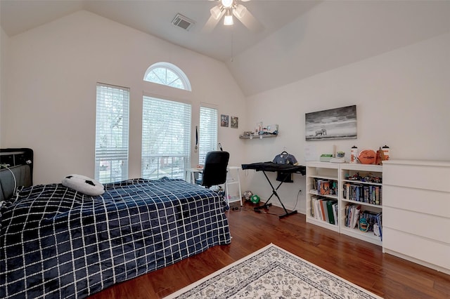 bedroom with vaulted ceiling, ceiling fan, and dark hardwood / wood-style flooring