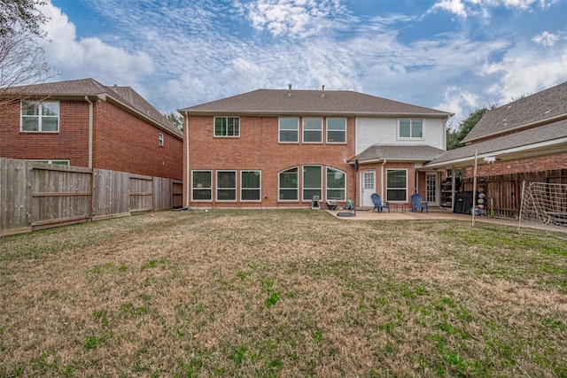 rear view of house with a patio area and a lawn