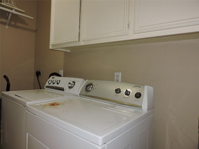 laundry area featuring cabinets and washer and clothes dryer