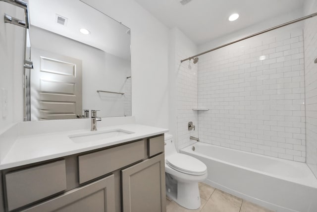 full bathroom featuring vanity, tile patterned floors, toilet, and tiled shower / bath