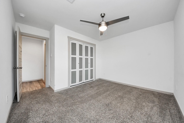 spare room featuring ceiling fan and carpet flooring