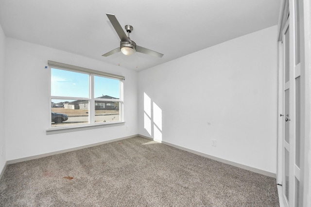 carpeted empty room with ceiling fan