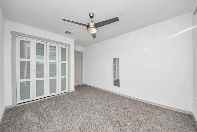 unfurnished bedroom with ceiling fan and carpet