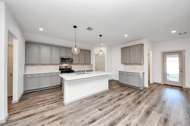 kitchen with sink, gray cabinets, and appliances with stainless steel finishes