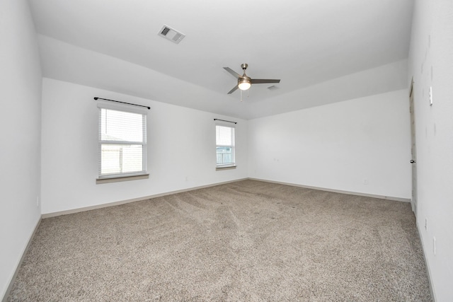 empty room with ceiling fan and carpet floors