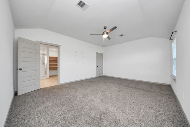 unfurnished bedroom with vaulted ceiling, light colored carpet, and ceiling fan