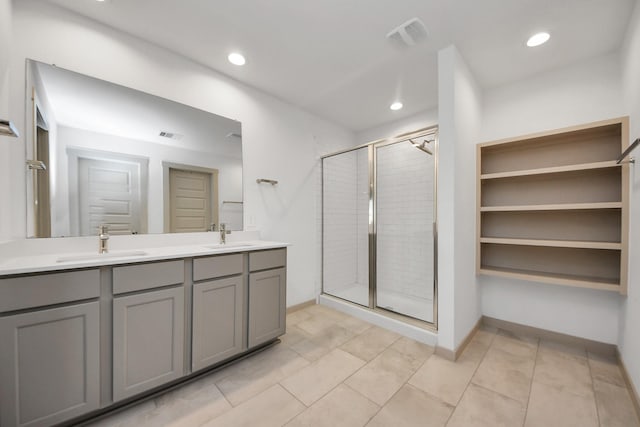 bathroom featuring vanity, tile patterned flooring, and walk in shower