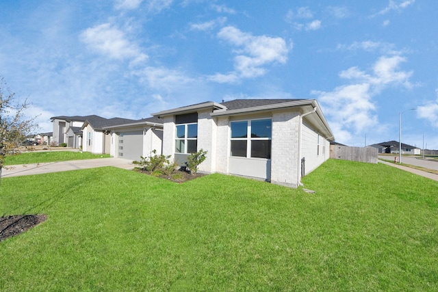 view of front of property featuring a garage and a front yard