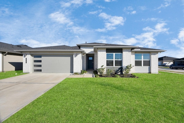 prairie-style home featuring a garage and a front lawn