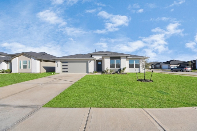 view of front of property with a garage and a front lawn