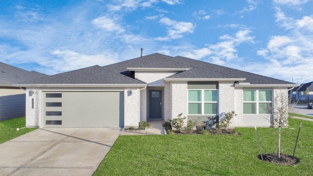 prairie-style home with a garage and a front lawn