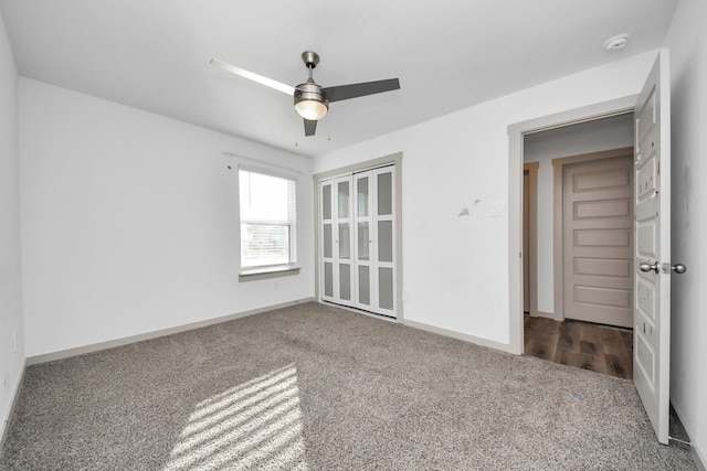 spare room featuring ceiling fan and carpet