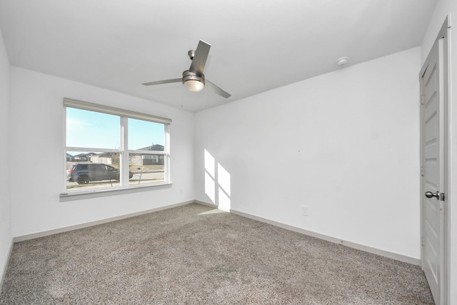 spare room with carpet floors and ceiling fan