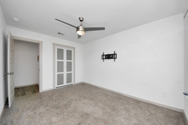 empty room with carpet floors and ceiling fan