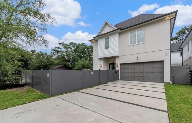 view of front of house with a garage and a front yard