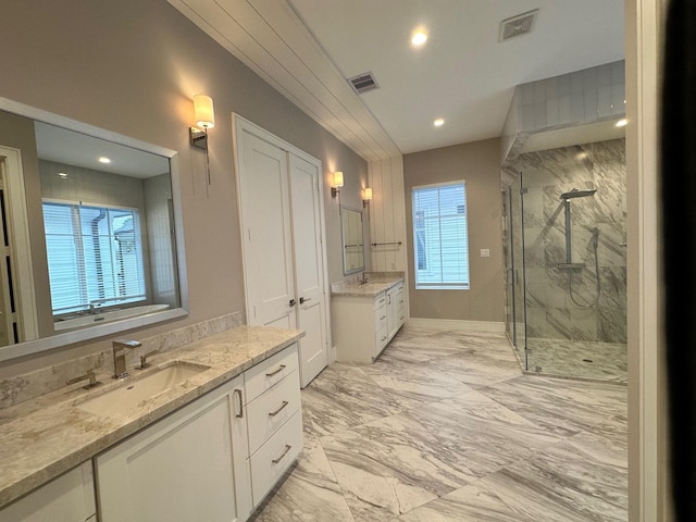 bathroom featuring vanity and a shower with door