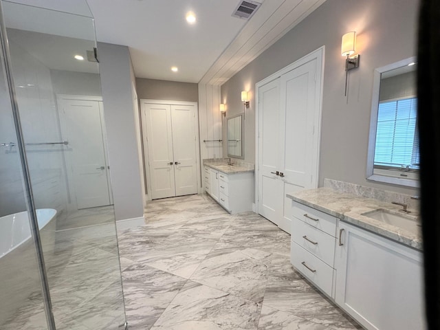 bathroom featuring vanity and independent shower and bath