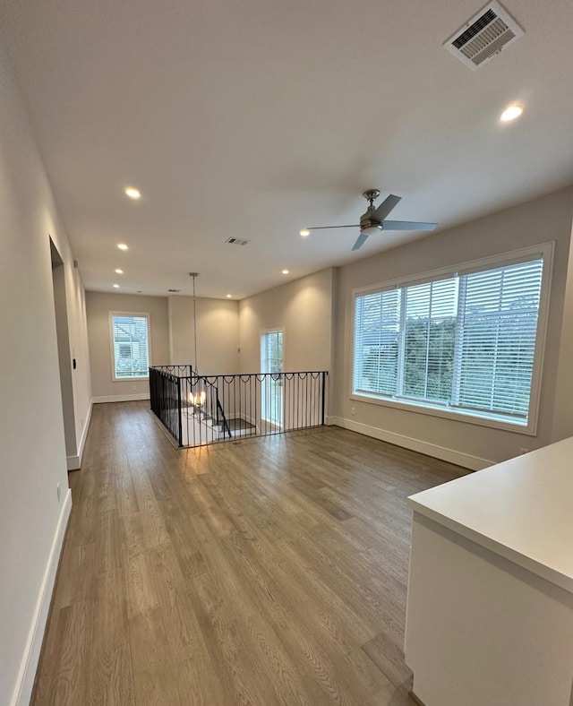 spare room featuring wood-type flooring and ceiling fan