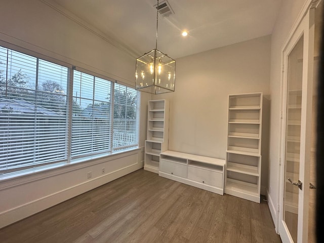 interior space featuring wood-type flooring and a chandelier