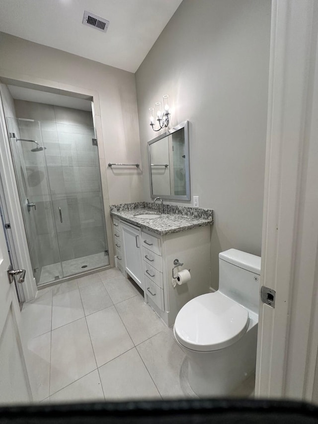 bathroom with vanity, tile patterned floors, toilet, and walk in shower