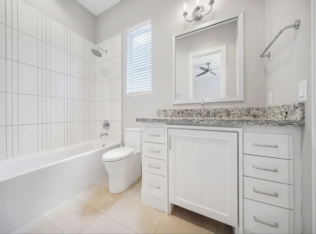 full bathroom featuring tiled shower / bath combo, vanity, tile patterned floors, and toilet