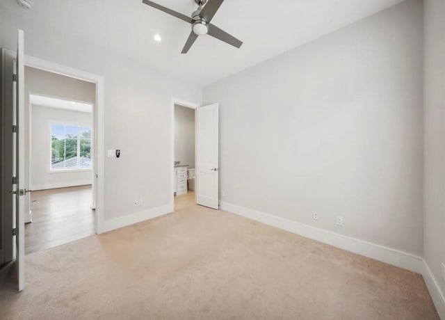 unfurnished bedroom with ceiling fan and light carpet