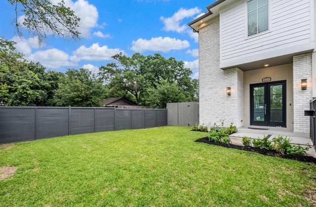 view of yard featuring french doors