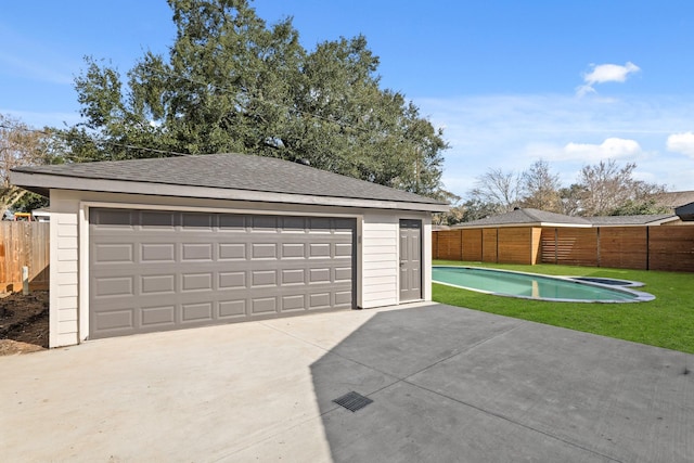 garage featuring a fenced in pool