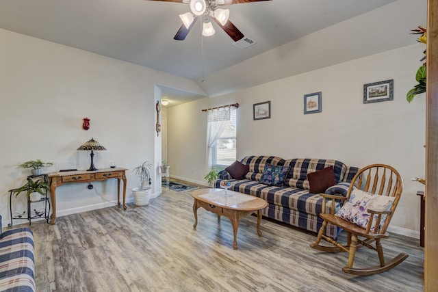 living room with lofted ceiling, hardwood / wood-style flooring, and ceiling fan