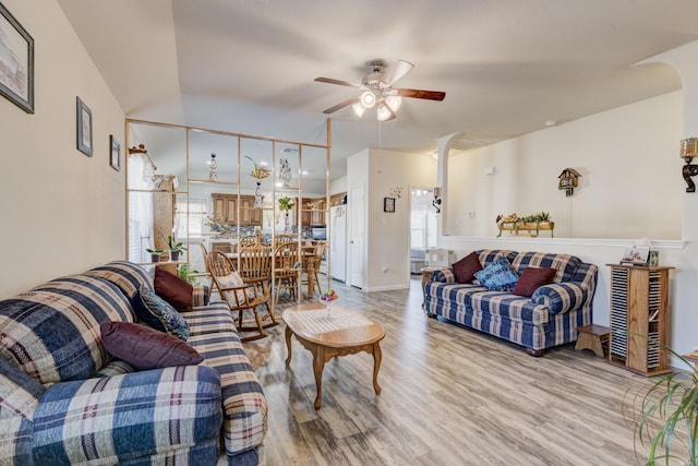 living room featuring hardwood / wood-style floors and ceiling fan