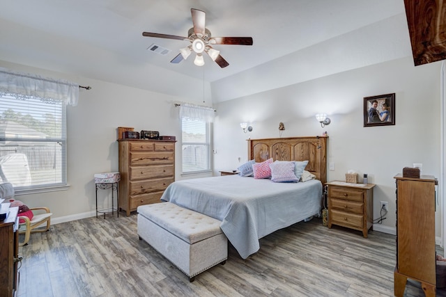 bedroom with lofted ceiling, hardwood / wood-style flooring, and ceiling fan