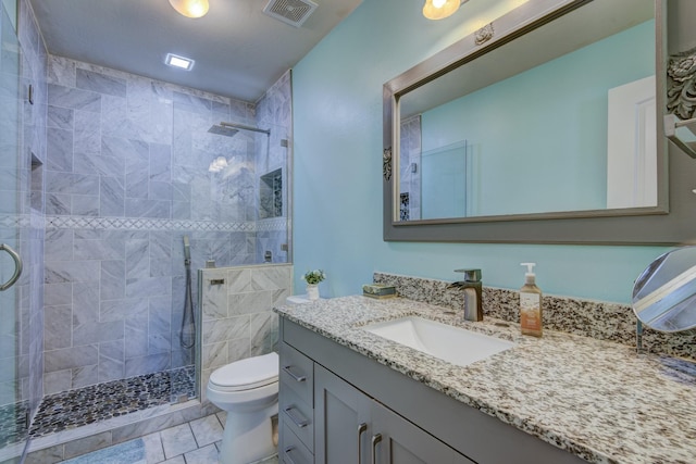 bathroom with vanity, toilet, and walk in shower