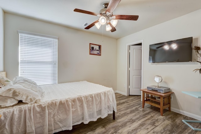 bedroom with hardwood / wood-style floors and ceiling fan