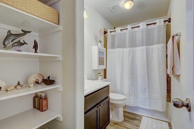 full bathroom featuring hardwood / wood-style flooring, vanity, shower / bathtub combination with curtain, and toilet