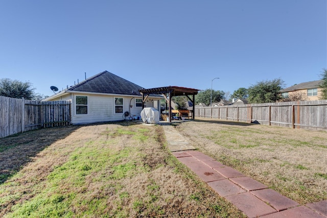 back of house featuring a pergola and a lawn