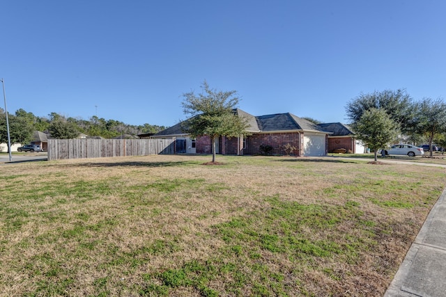 view of front of house featuring a garage and a front yard