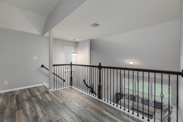 hallway with hardwood / wood-style floors