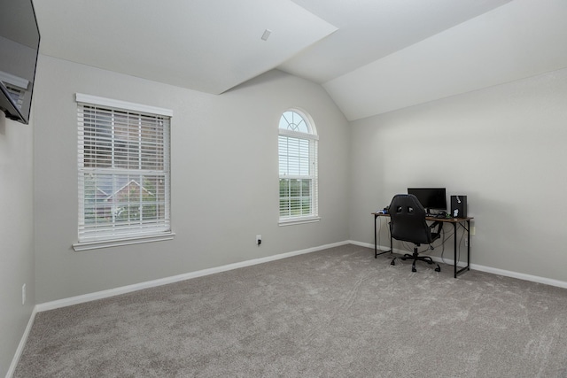 office area with light carpet and vaulted ceiling