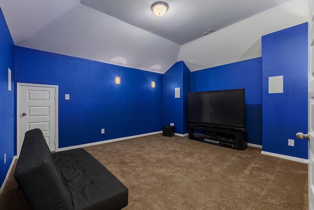 cinema room with vaulted ceiling and dark carpet