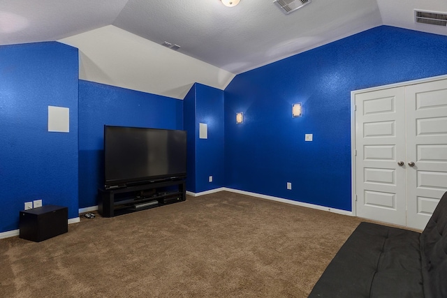 cinema with lofted ceiling and carpet flooring