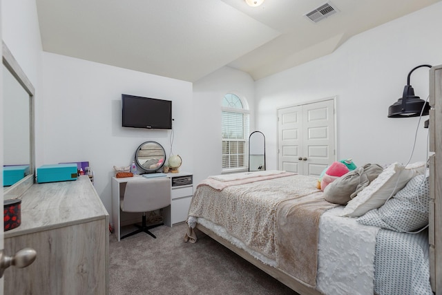 carpeted bedroom featuring lofted ceiling