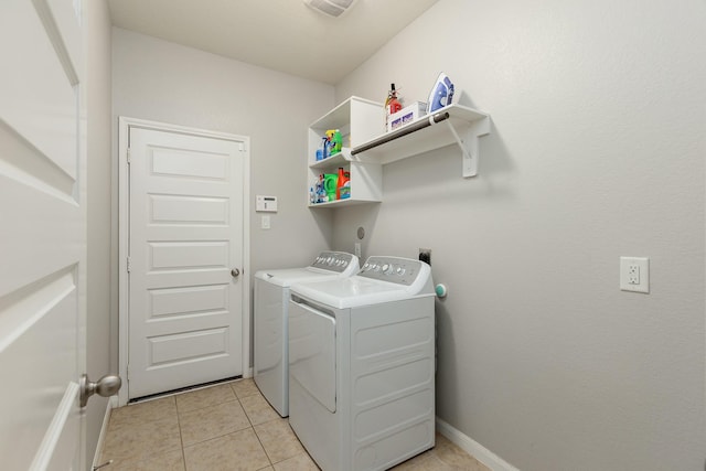 laundry room with light tile patterned floors and independent washer and dryer